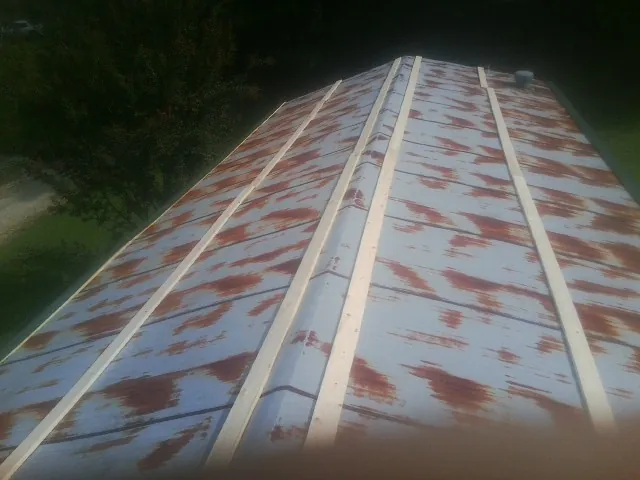 Rusted metal roof panels with new wood purlins before replacement — Storm Damage Roof Repair in Highland Mills by Roofing Brothers