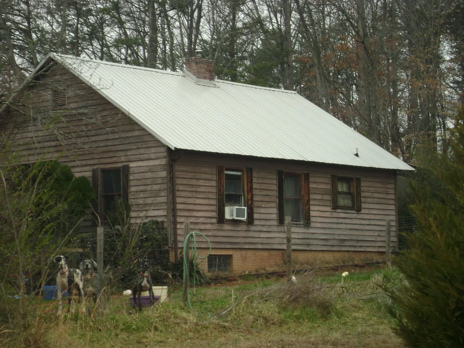 White metal roof on an old wood sided farmhouse, from a Asphalt Shingle Roof Repair job in Highland Mills